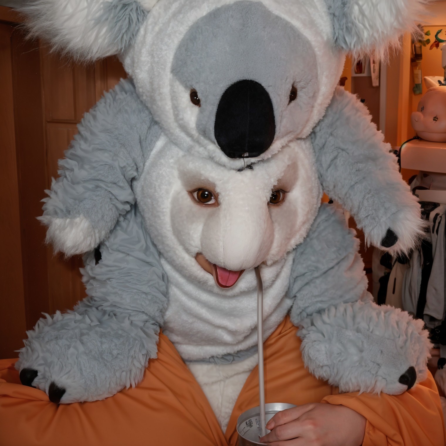 Playful Person in Fluffy Koala Costume with Drink