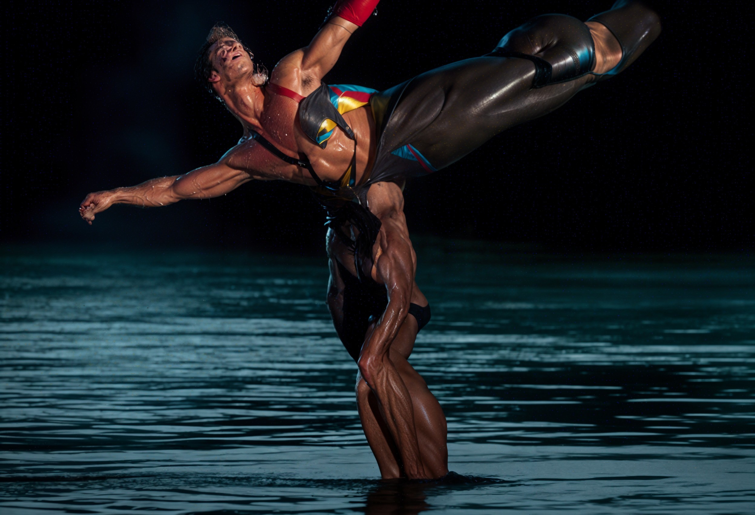 Male Acrobats Performing Dramatic Lift Above Water