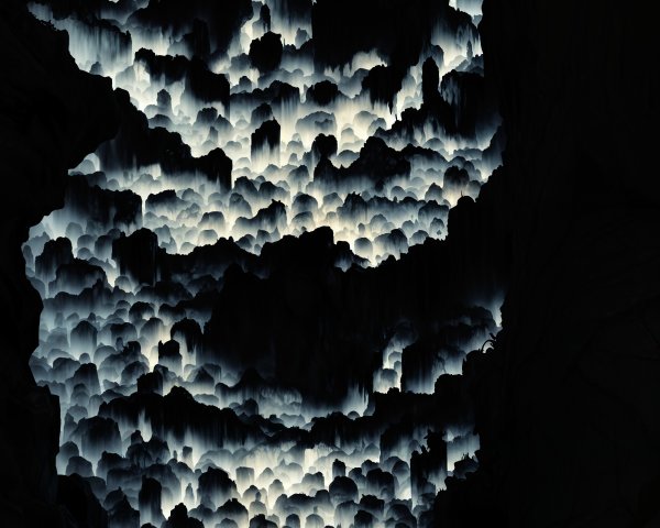 Lone Figure at Cave Entrance with Ethereal Lighting