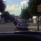 Vintage Car on Tree-Lined Street in Nostalgic Setting
