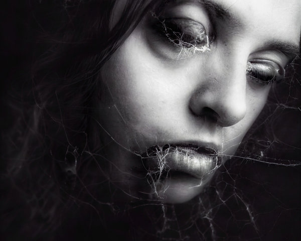 Ethereal Portrait of a Young Woman with Spiderwebs