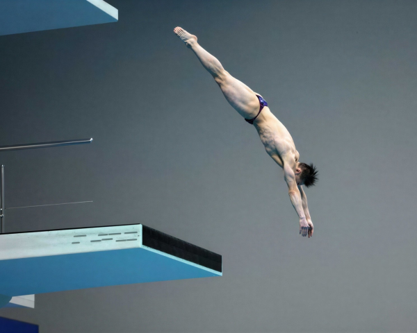 Male Diver in Vertical Entry Pose at Competition
