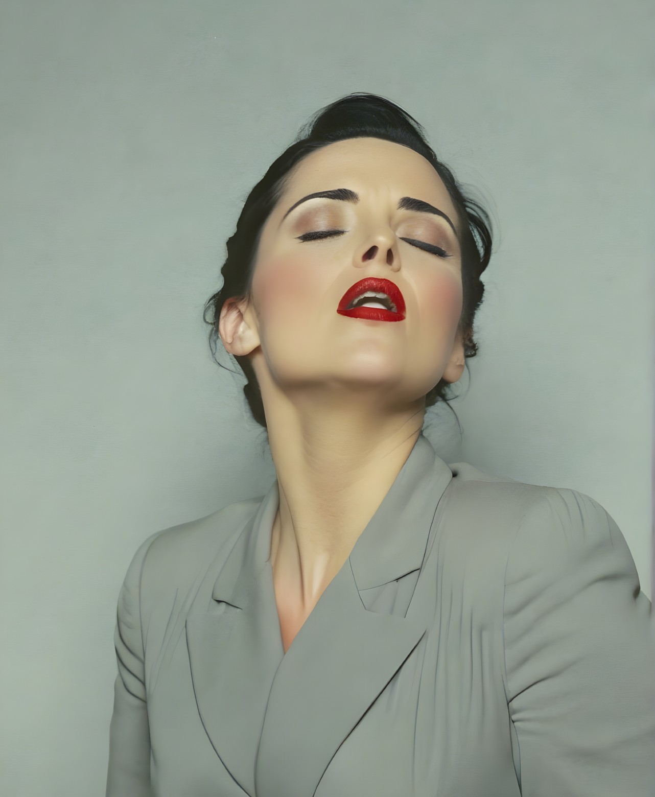 Elegant Woman in Gray Blazer with Updo and Red Lips
