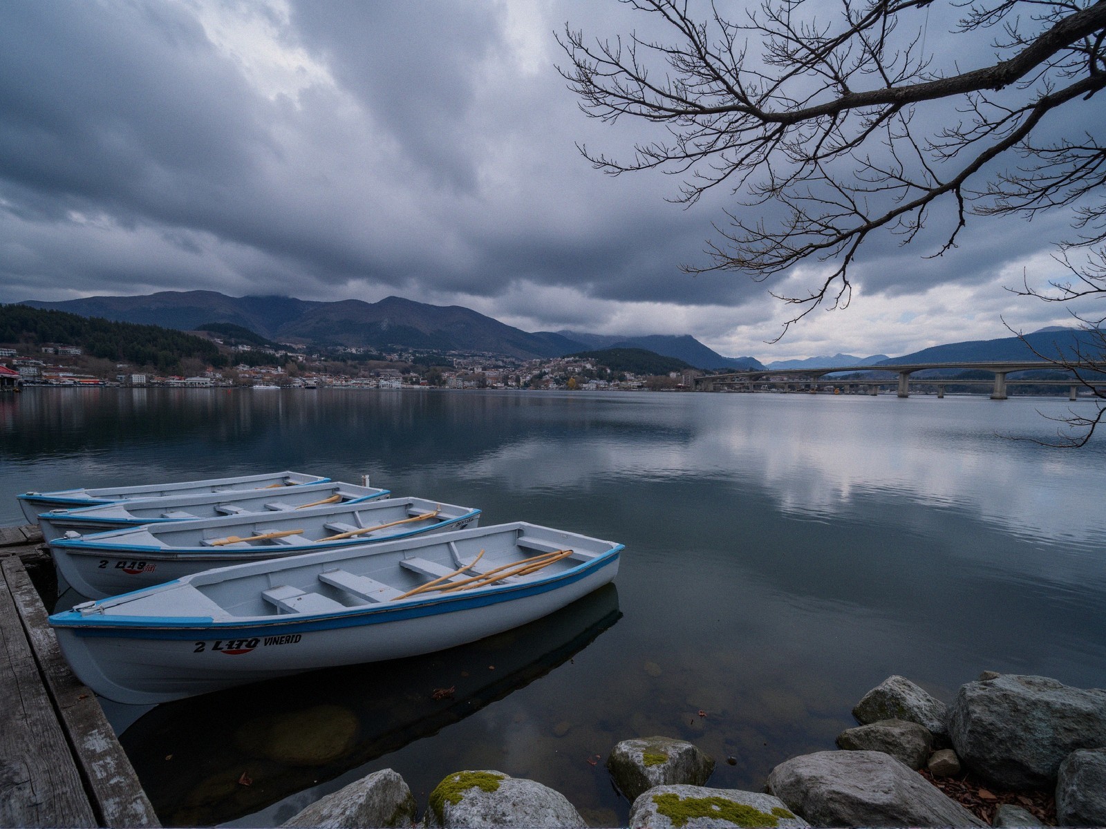 Serene Waterscape with Boats and Overcast Sky