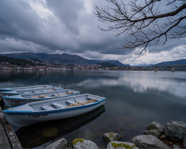 Serene Waterscape with Boats and Overcast Sky