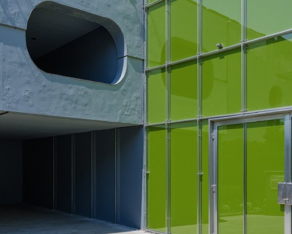 Modern Building with Gray Concrete and Green Glass Panels