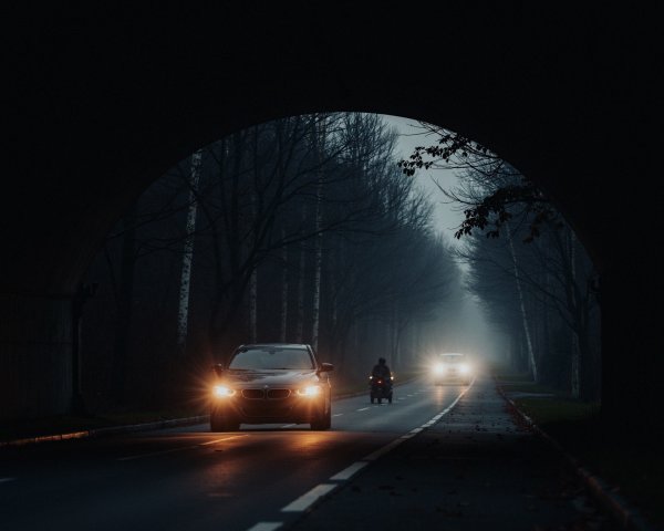 Foggy Scene with Vehicles Emerging from a Tunnel