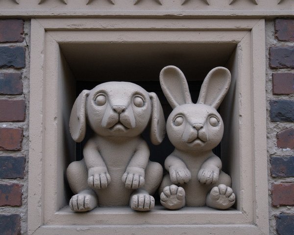 Textured Stone Relief of Cartoon Animals in Window