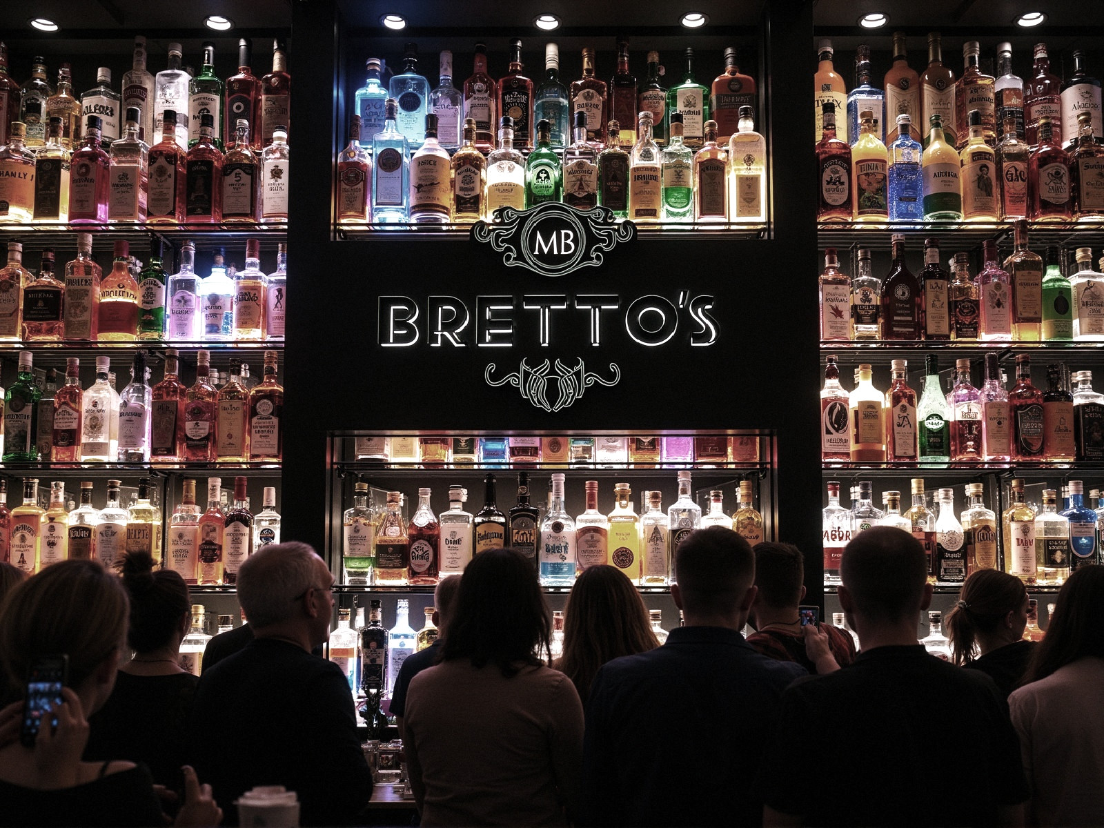 Stylish Bar with Colorful Liquor Display and Patrons