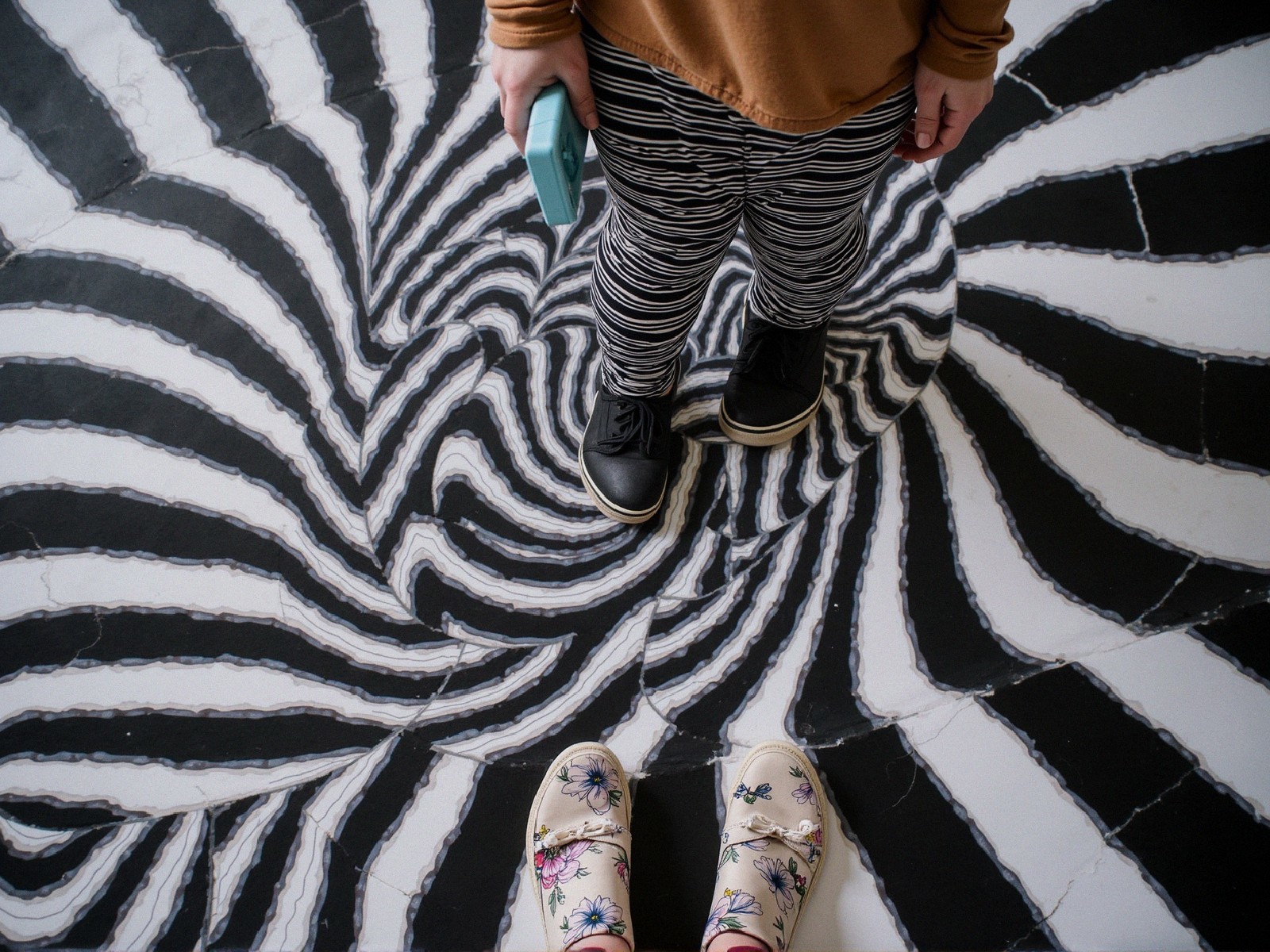 Black and White Spiral Pattern with Child and Adult Feet