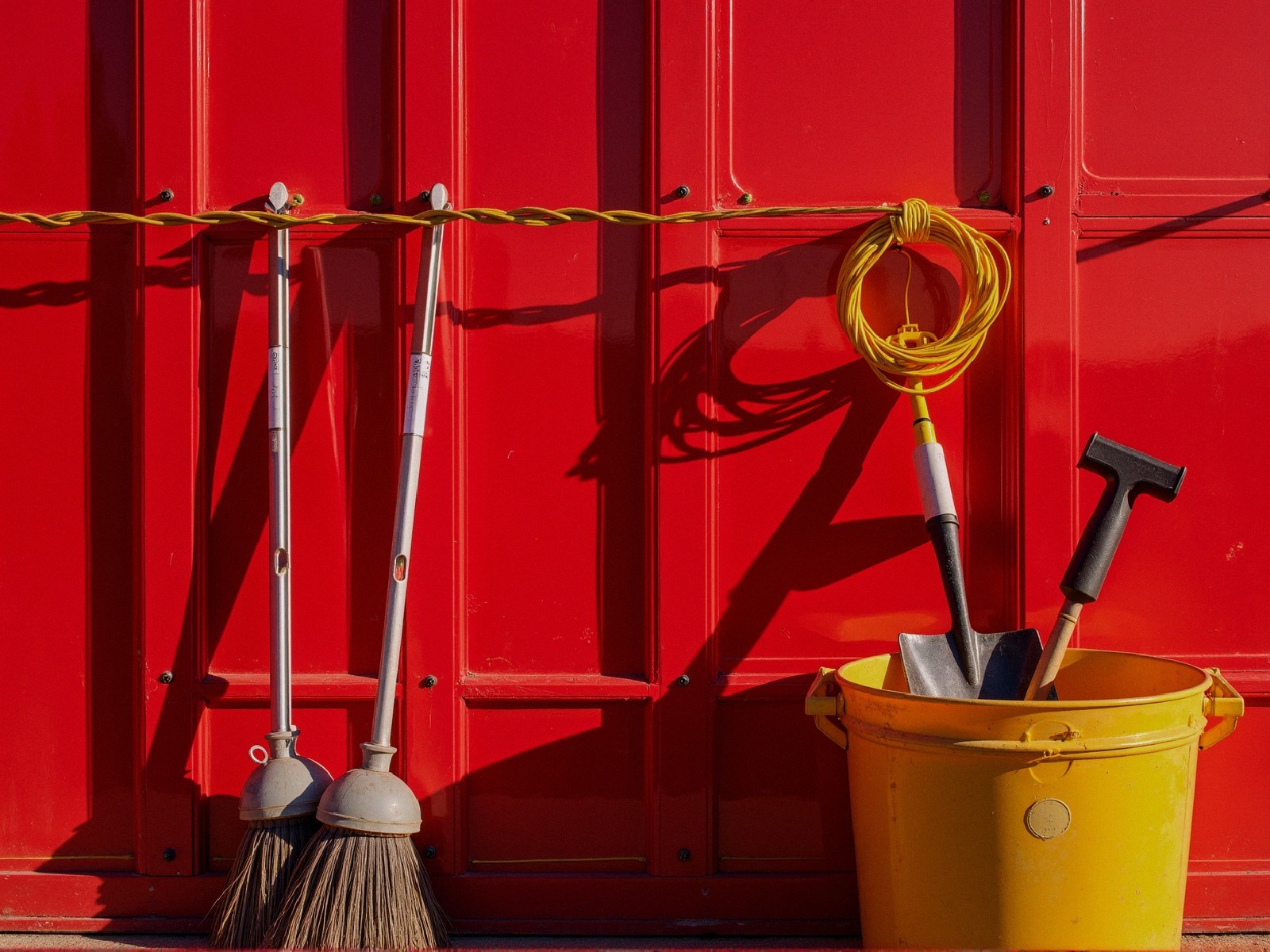 Bright Red Wall with Cleaning Tools and Accessories