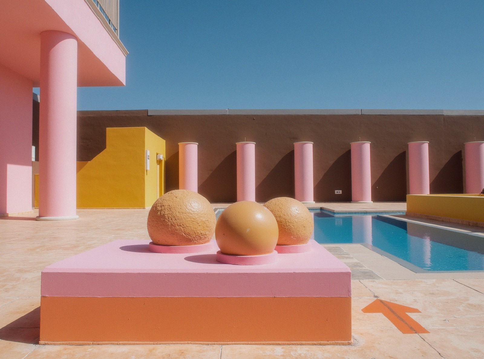 Vibrant Outdoor Pool Area with Geometric Sculptures