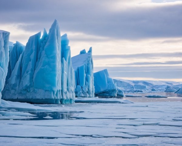 Icy Landscape with Blue Icebergs and Calm Water
