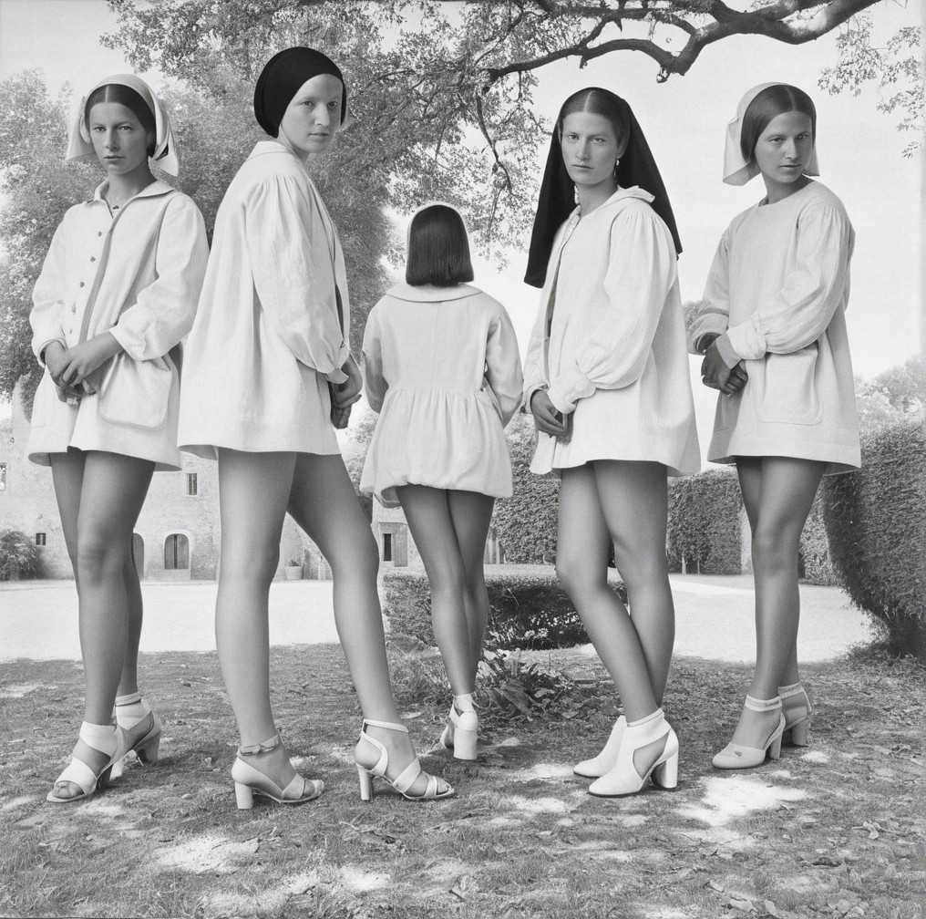 Five Women in White Outfits in Serene Outdoor Setting