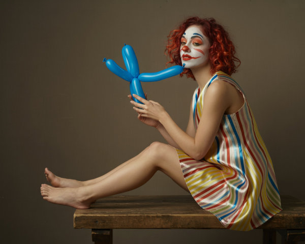 Playful Clown with Colorful Outfit and Balloon Animal