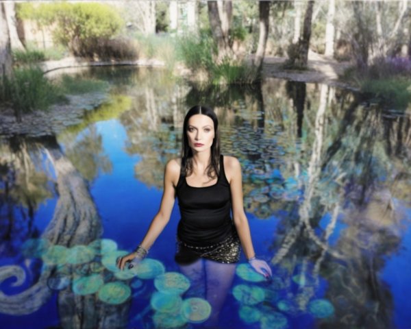 Woman in Black Outfit by Blue Water and Lily Pads