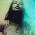 Young woman in lace dress with serene expression