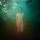 Solitary Woman in Ethereal Misty Landscape