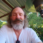 Man with Long Hair and Beard in Outdoor Setting