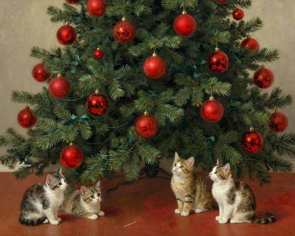 Kittens by a Christmas tree with red ornaments and bows