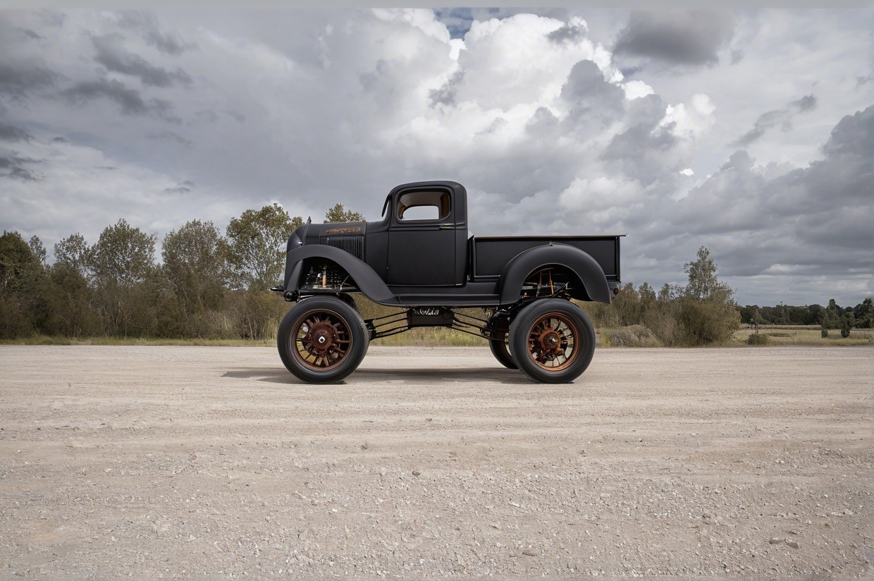 Vintage truck on dirt road with lush greenery backdrop