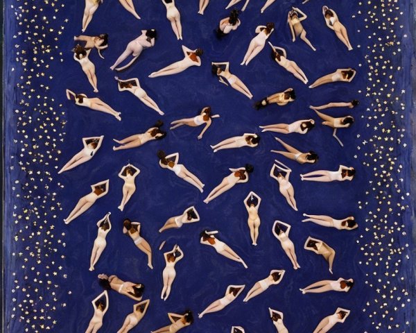 Aerial View of Individuals on Deep Blue Surface