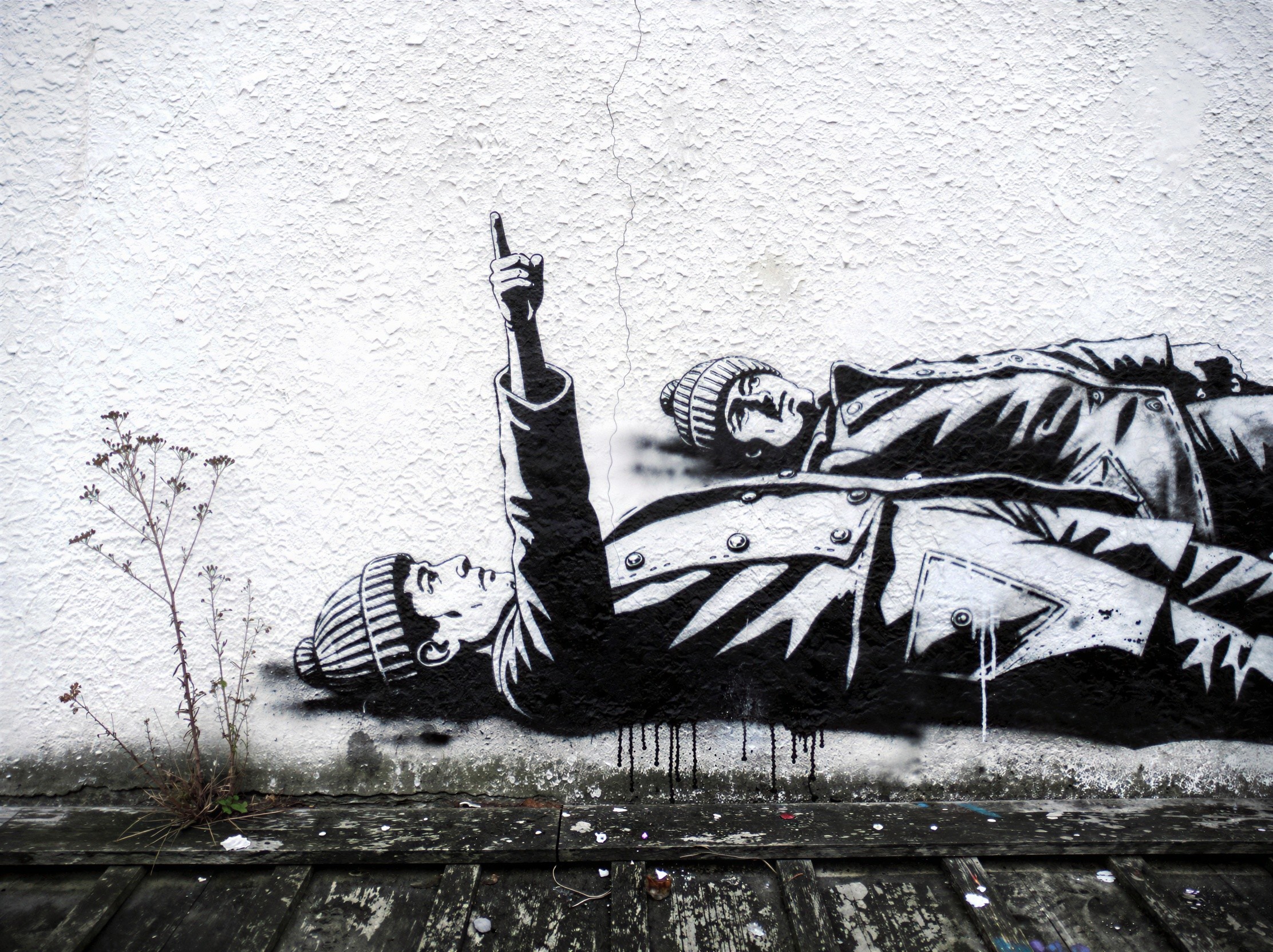 Two-tone black and white stencil graffiti of figures