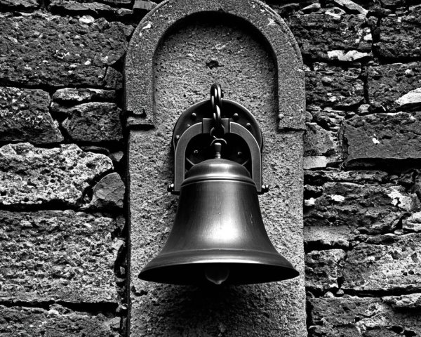 Vintage Bell on Textured Stone Wall Background
