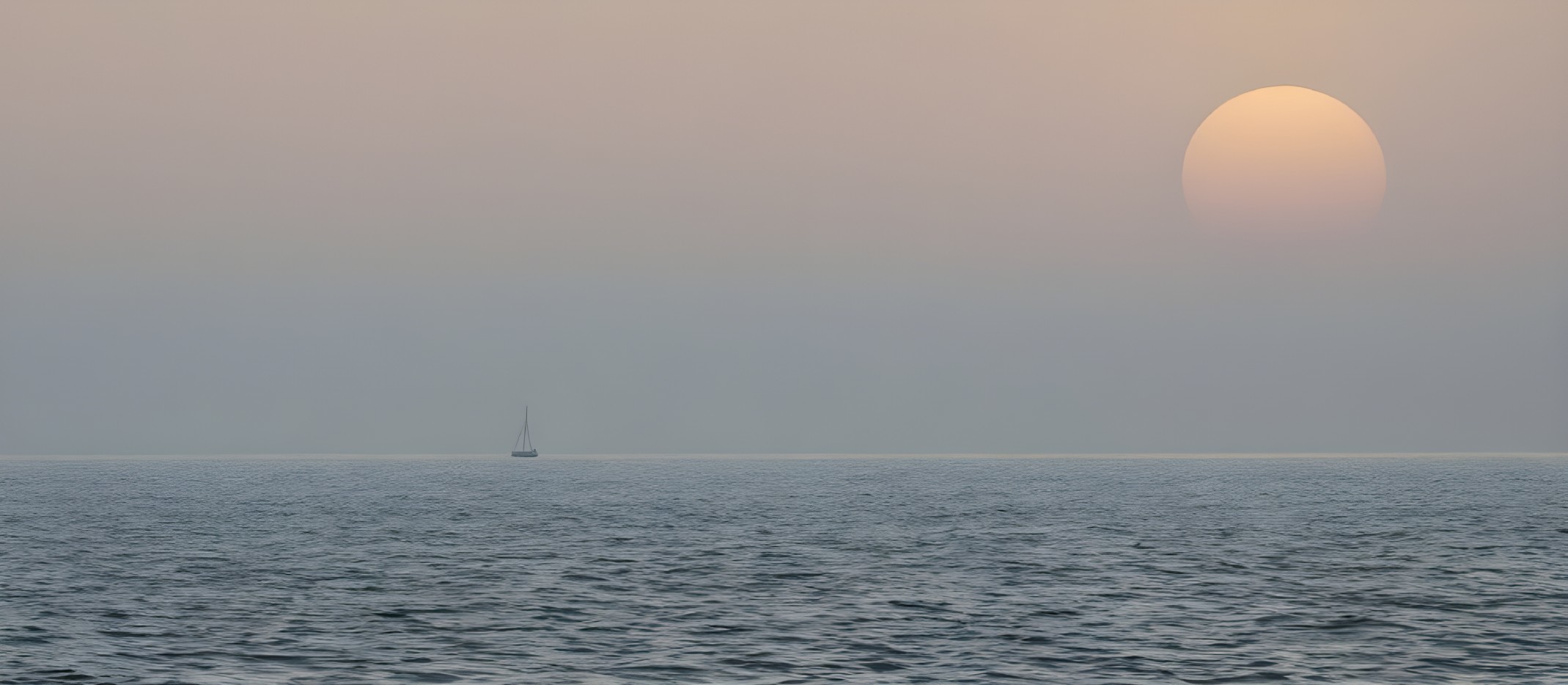 Tranquil Sunset Seascape with Sailboat on Calm Waters