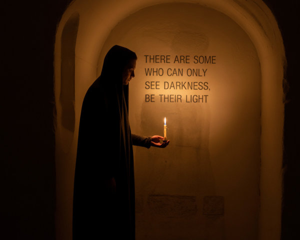 Figure in Dark Robe with Candle in Illuminated Alcove