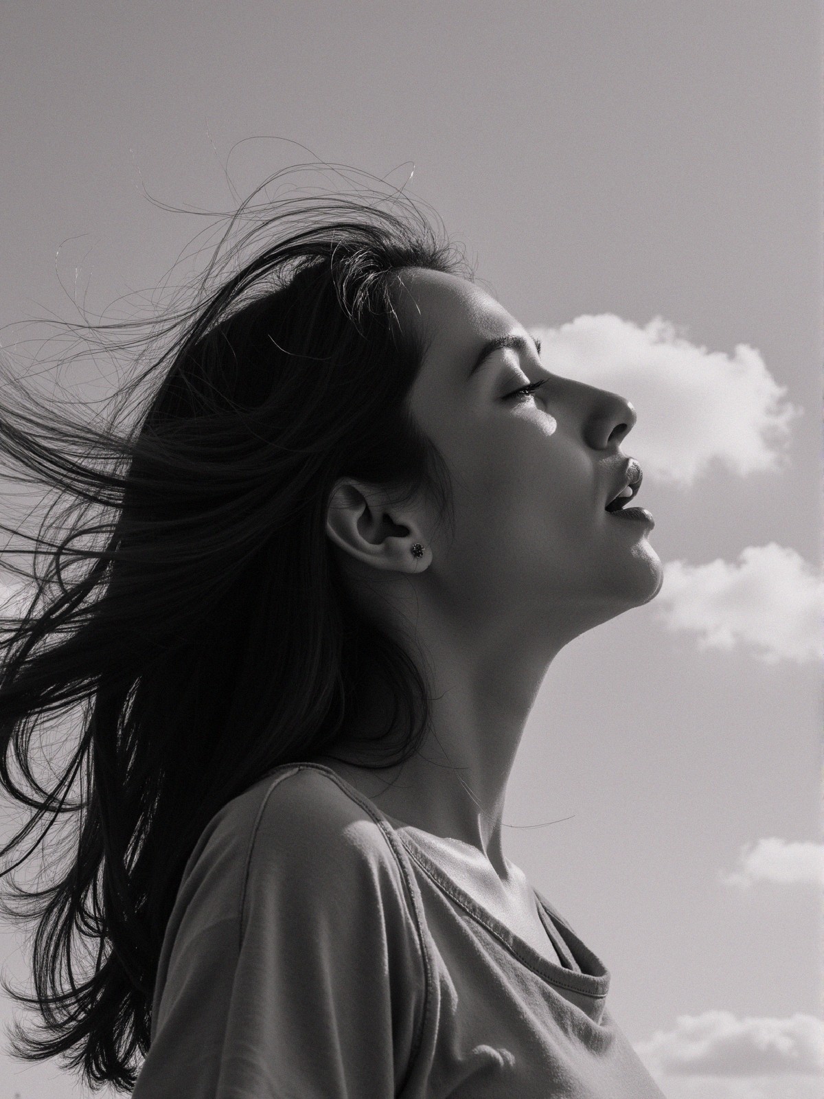 Profile of a Woman with Long Hair Against a Sky