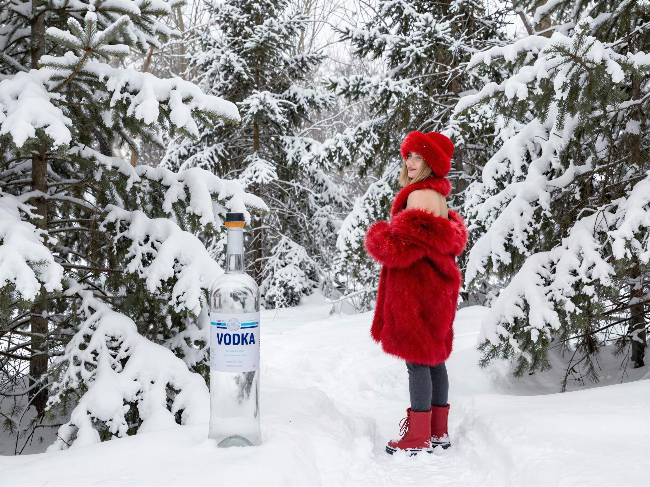 Caucasian Woman in Red Coat in Snowy Forest Setting