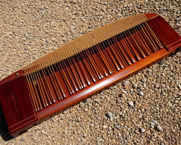 Kalimba on Gravel with Polished Wood and Metal Tines