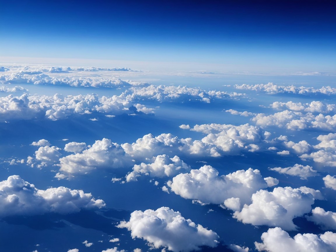 Aerial View of Fluffy Clouds in Bright Blue Sky