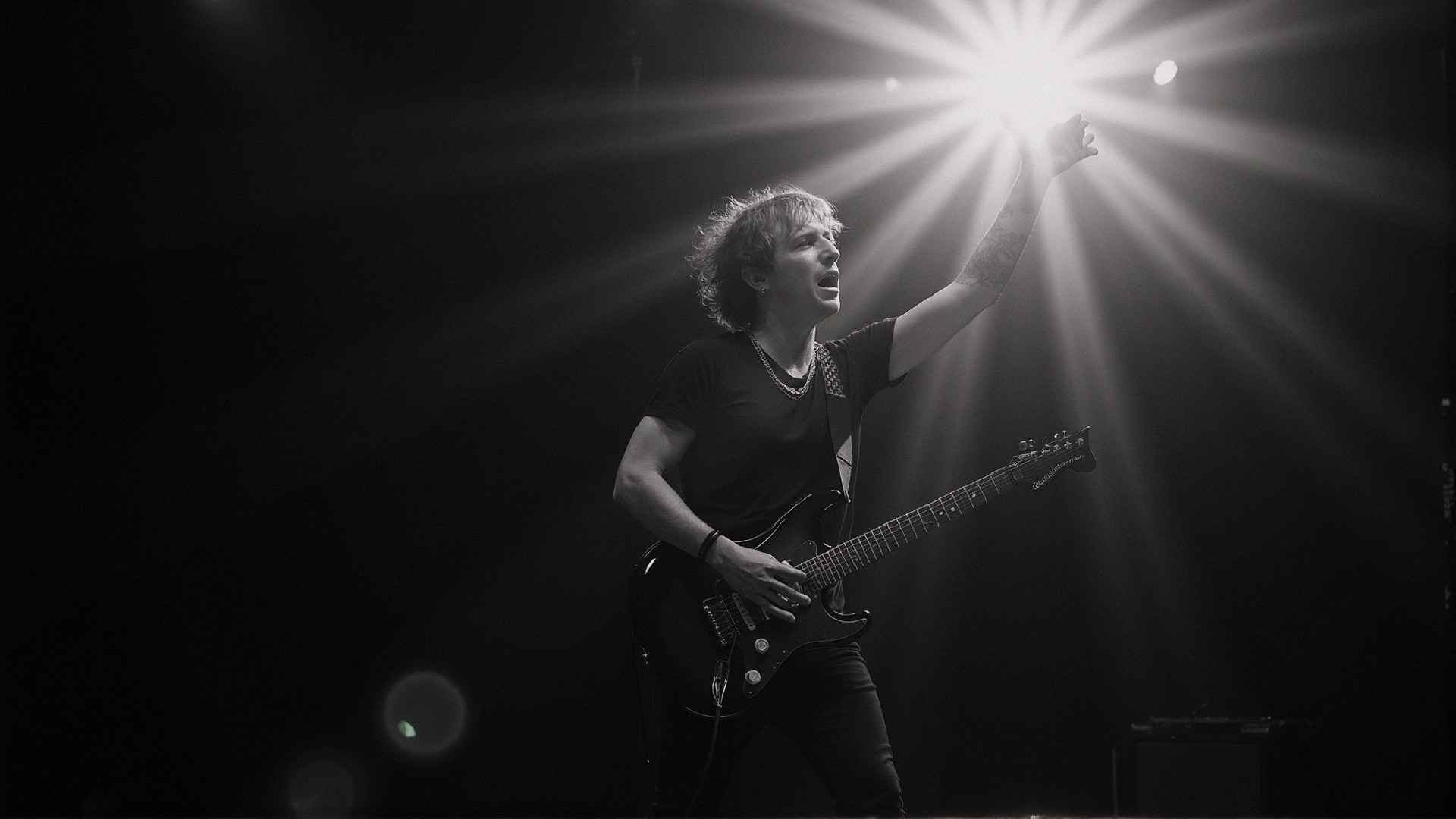 Guitarist Performing on Stage in Dramatic Lighting