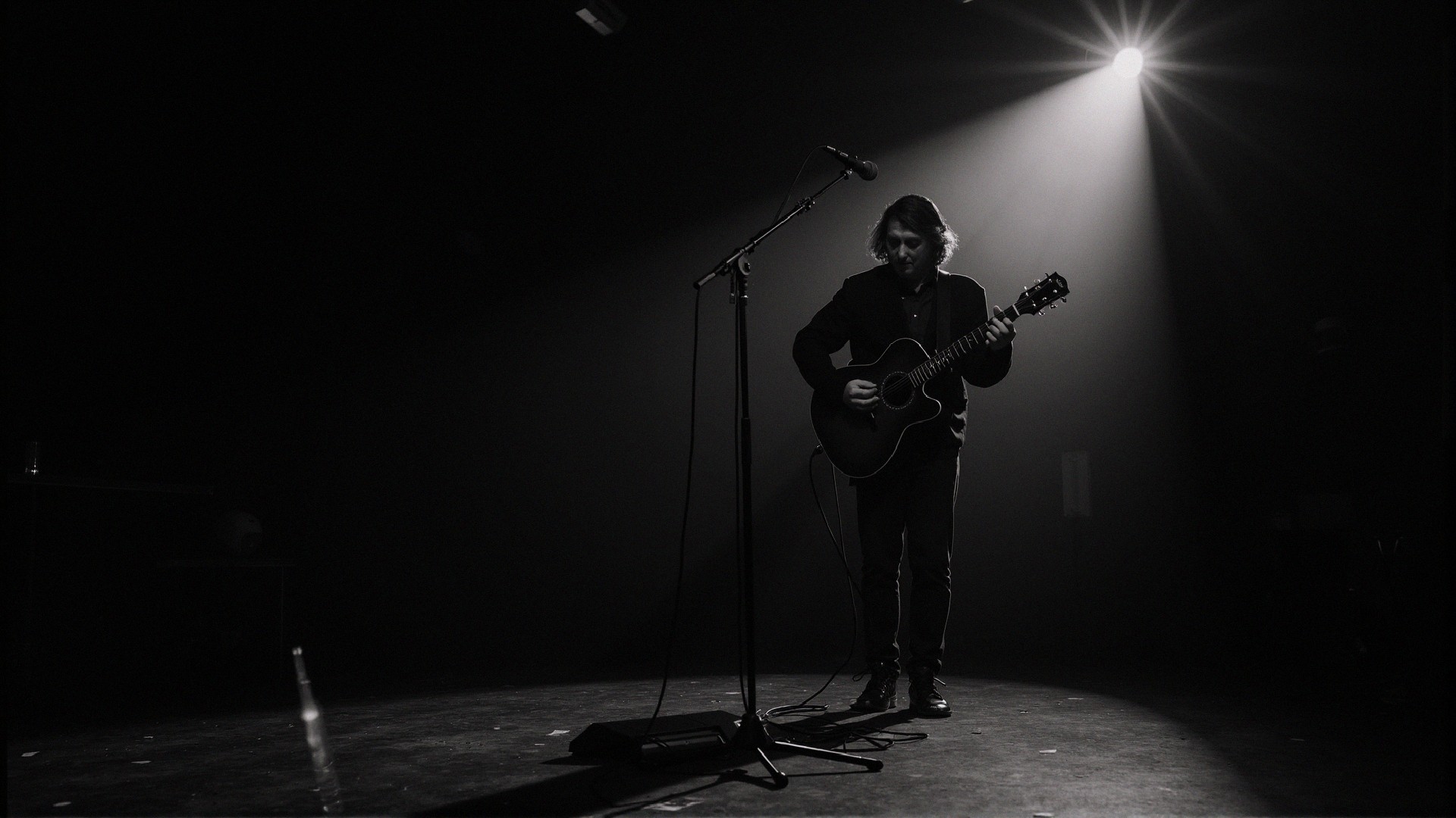 Solitary Musician with Acoustic Guitar on Stage