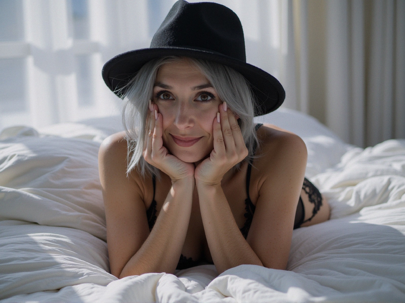 Woman with Silver Hair in Black Lingerie on Bed