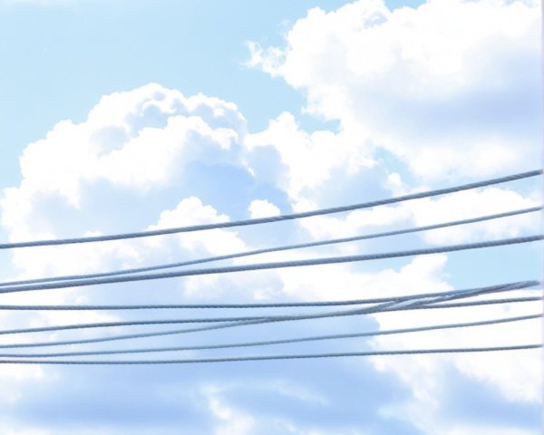 Serene Sky with Fluffy Clouds and Power Lines
