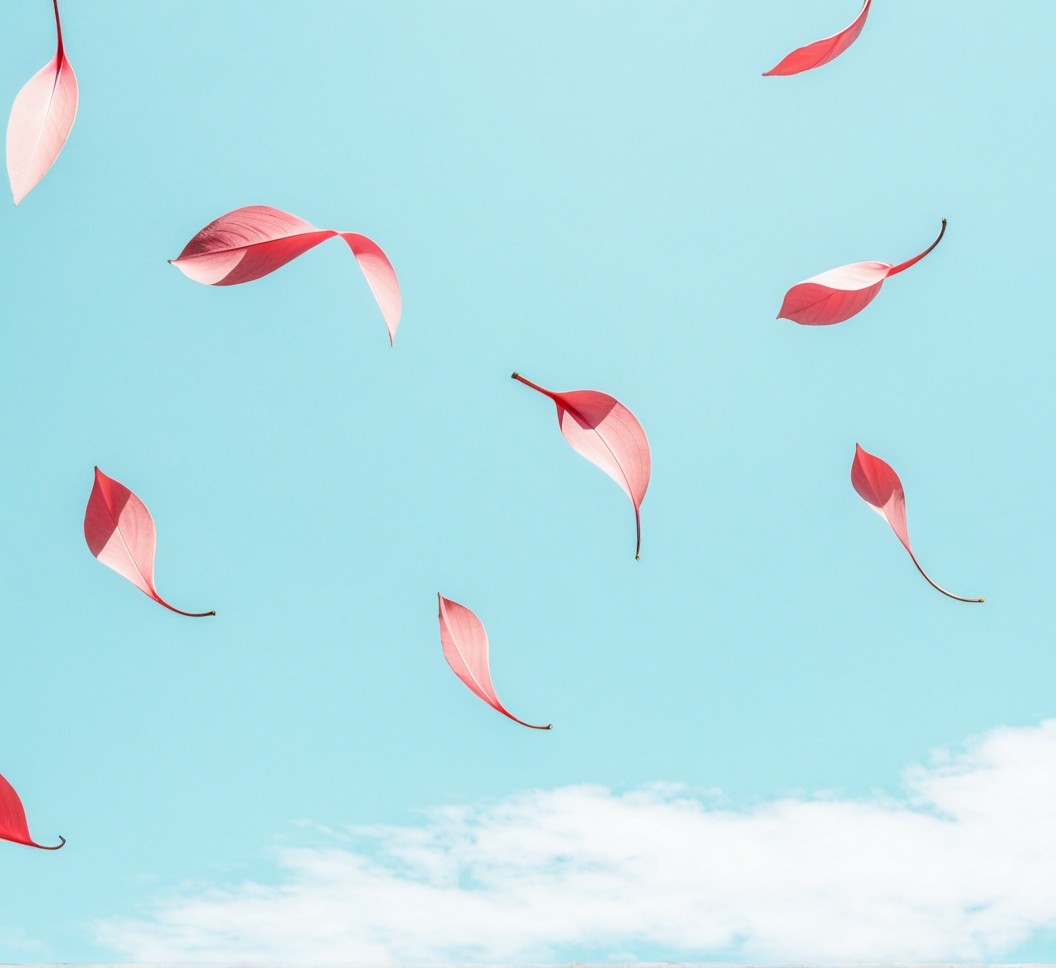 Floating Pink Leaves Against a Blue Sky Background