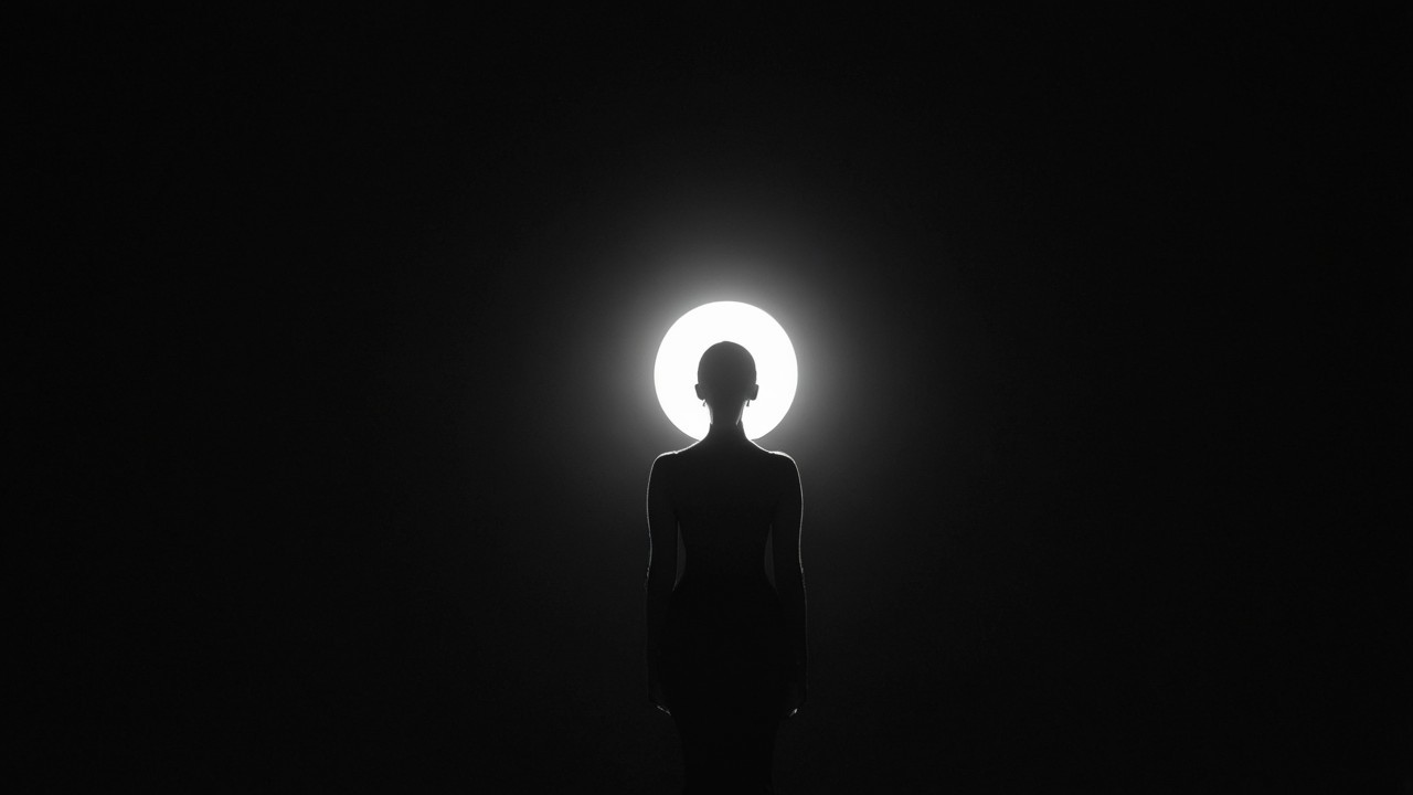 Solitary Figure in Bright Light Against Dark Background