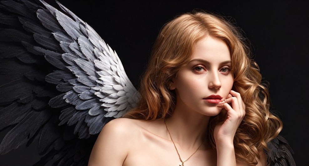 Young woman with striking wings in dark setting