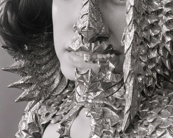 Close-Up Portrait of Person in Textured Metallic Outfit with Spiky Accents