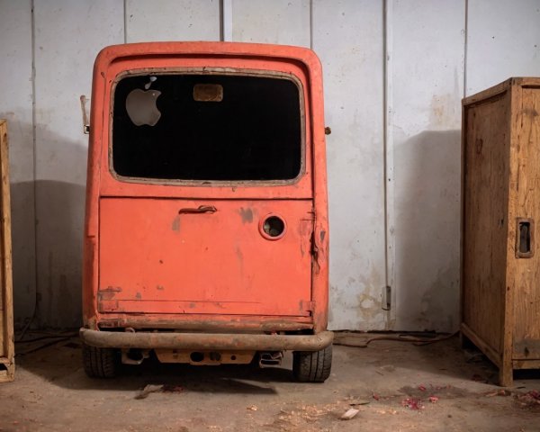 Rusty Orange Vehicle with Unique Apple Logo Cut-Out