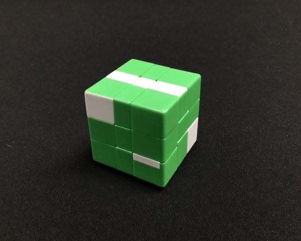Green and White Partially Solved Rubik's Cube on Black