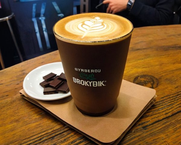 Warm Latte with Leaf Design and Dark Chocolate Pieces