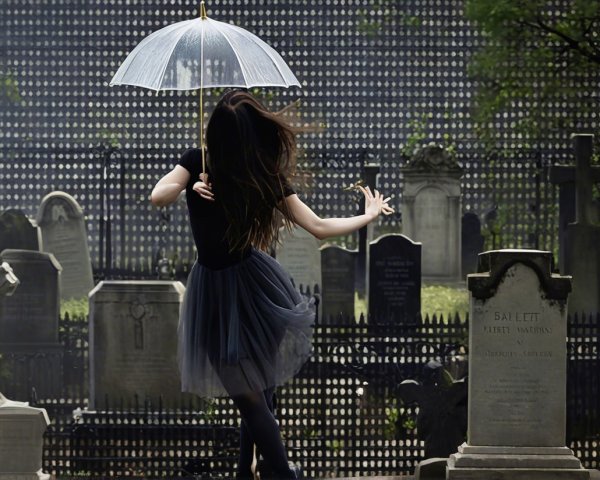Dancer in Black Tutu Twirls in Misty Cemetery