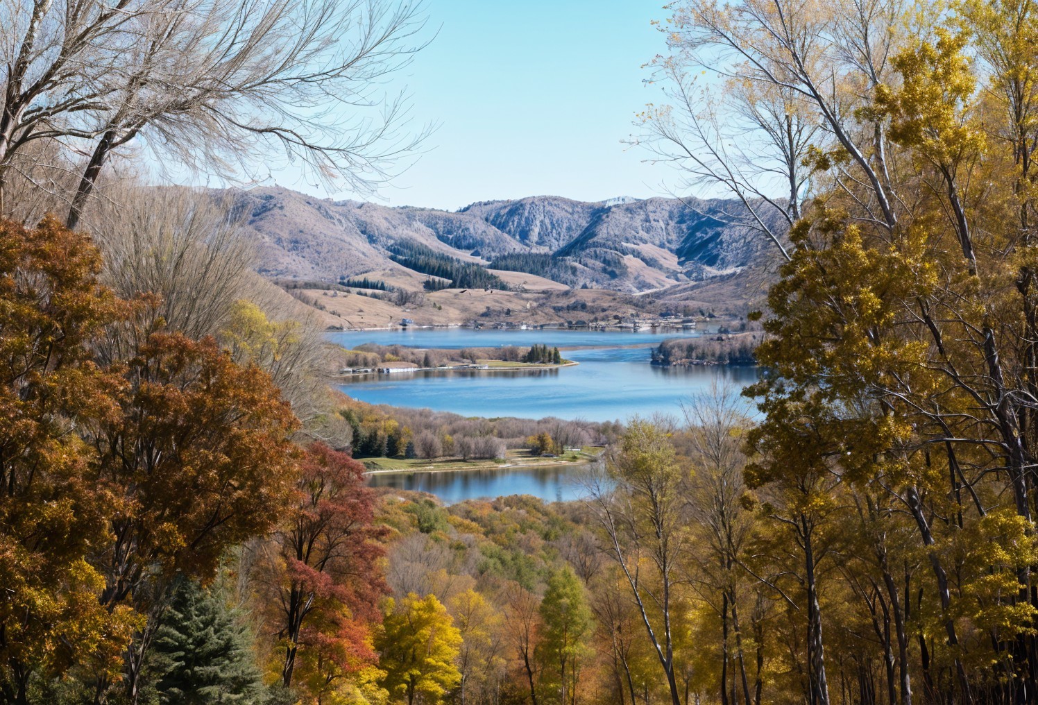 Tranquil Lake Surrounded by Autumn Foliage and Hills