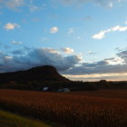 Flat-topped mountain with golden fields at dusk