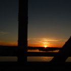 Sunset Over Water Framed by Bridge Silhouettes