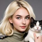 Young woman with cat against gray background